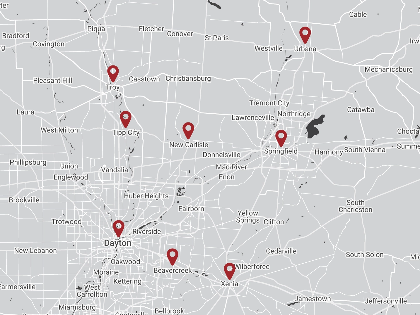 A grayscale map highlighting various cities in Ohio, including Dayton, Troy, Tipp City, New Carlisle, Springfield, Urbana, Beavercreek, and Xenia. Red markers indicate specific locations offering septic service.